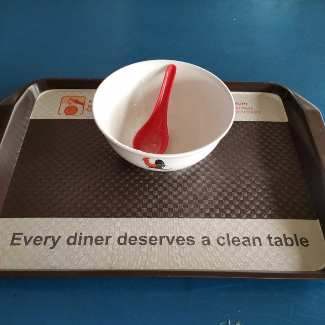 Subtle reminder sticker on food tray to clear the table after a meal